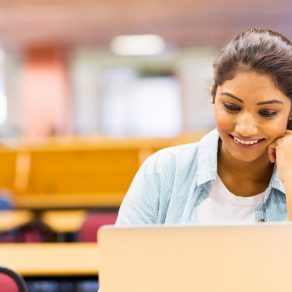 Young Asian Indian Businessman working on laptop in office