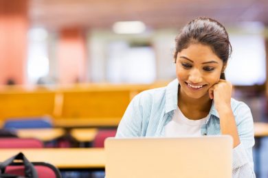 Young Asian Indian Businessman working on laptop in office
