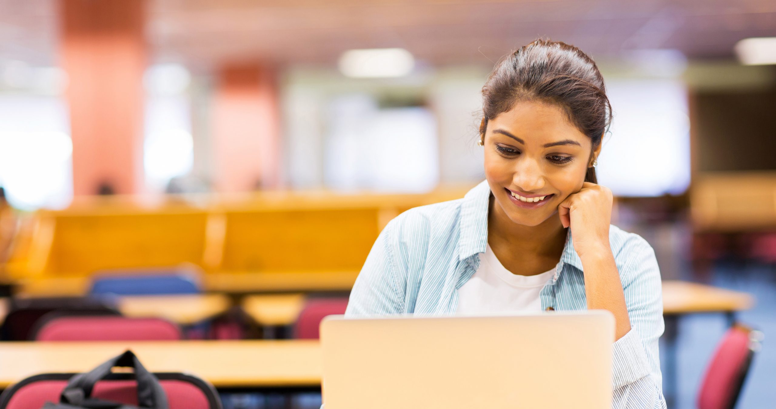 Young Asian Indian Businessman working on laptop in office